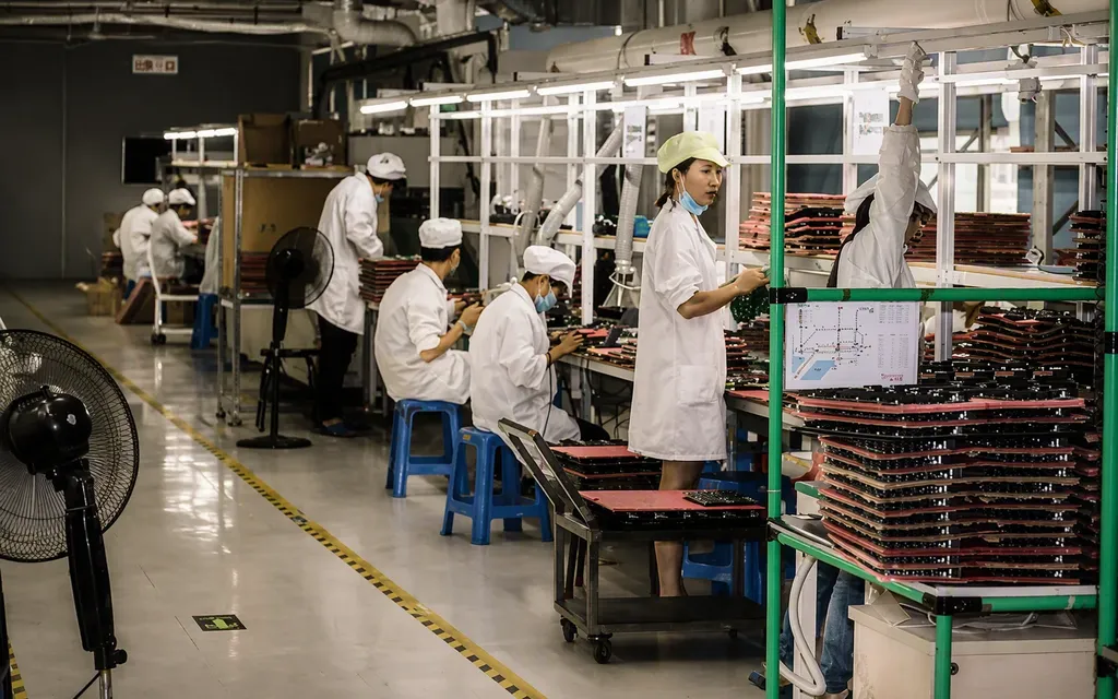 Assembly workstation with operators in coats — box-build area