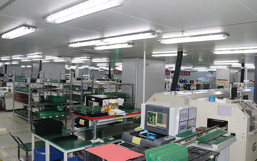 SMT workshop worked desks with green PCBs at Huaxing
